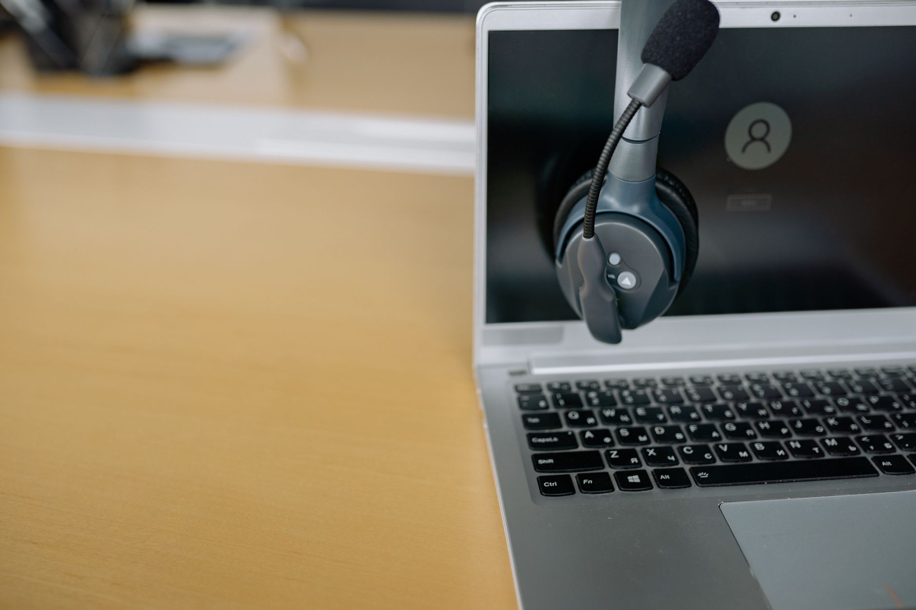Headset hængt på en bærbar med logindækket